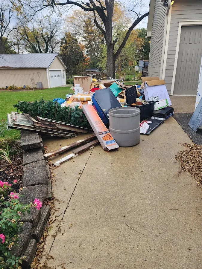 Dumpster being loaded with debris for 12 Yard Dumpster Rental in Mount Morris